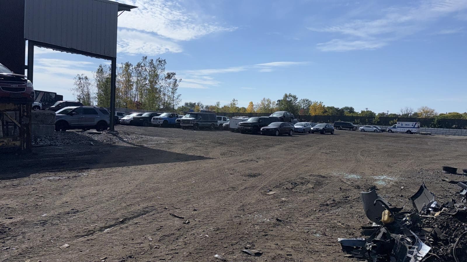 Rows of vehicles parked at the Detroit Junk Car Recycling yard