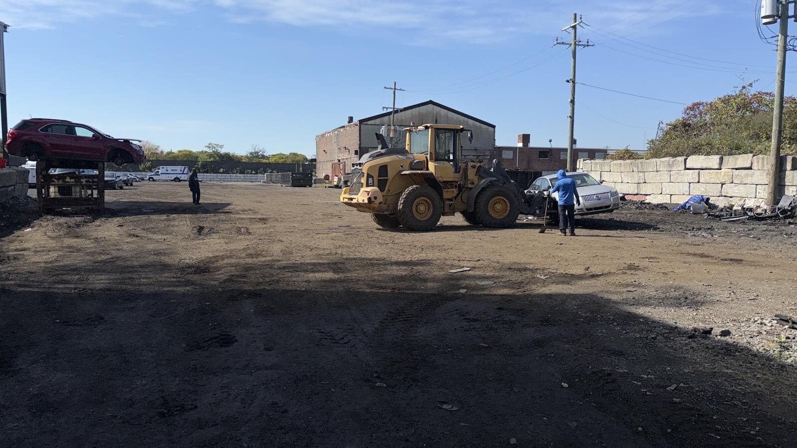 Loader moving material across the yard